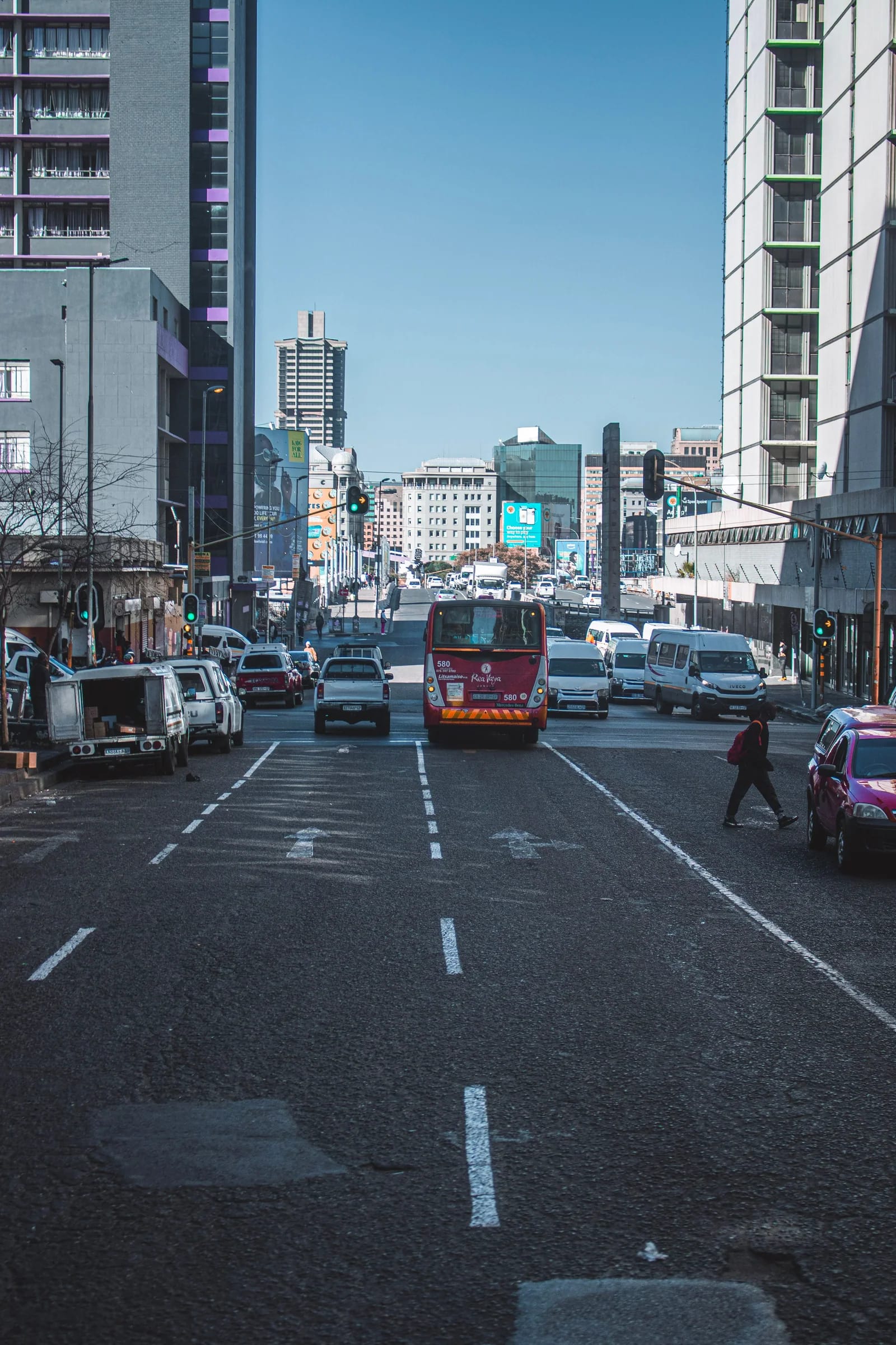 Traffic, buses, and pedestrians moving through central Johannesburg